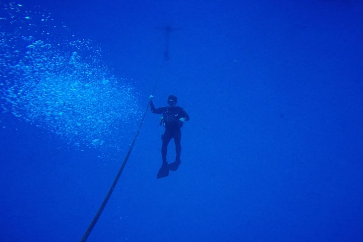 Scuba diver underwater in distance